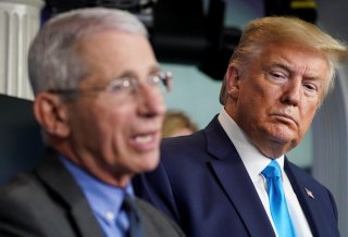 U.S. President Donald Trump listens as Dr. Anthony Fauci, director of the National Institute of Allergy and Infectious Diseases, addresses the daily coronavirus task force briefing at the White House in Washington, U.S., April 7, 2020. REUTERS/Kevin Lamar