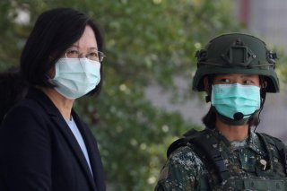 Taiwanese president Tsai Ing-Wen, wearing a mask, observe soldiers demonstrate drills at a military base camp in Tainan, Taiwan, April 9, 2020. REUTERS/Ann Wang