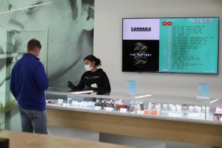 Ashlee Mason, 26, serves a customer at The Pottery Cannabis Dispensary, as marijuana deliveries increase amid the spread of the coronavirus disease (COVID-19), in Los Angeles, California, U.S., April 14, 2020. REUTERS/Lucy Nicholson