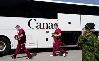A bus carrying Canadian Armed Forces (CAF) medical personnel arrives at Villa Val des Arbres, a seniors' long-term care centre, to help amid the outbreak of the coronavirus disease (COVID-19), in Montreal, Quebec, Canada April 20, 2020. REUTERS/Christinne
