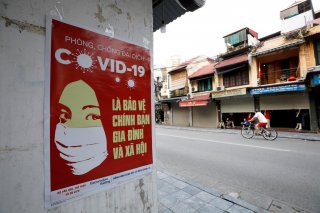 A poster warning about the coronavirus disease (COVID-19) is seen on a street in Hanoi, Vietnam April 20, 2020. REUTERS/Kham
