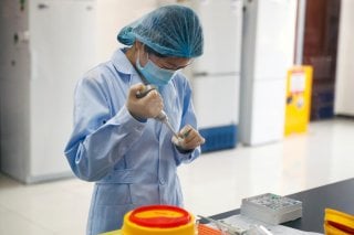 An employee works at the R&D laboratory of the Beijing Applied Biological Technologies Co. during a government organised tour of the facility following the outbreak of the new coronavirus disease (COVID-19), in Beijing, China, May 14, 2020. REUTERS/Thomas