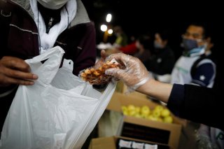 An elderly man receives food aid handouts for the needy, as the spread of the coronavirus disease (COVID-19) continues in Tokyo, Japan, May 9, 2020. Picture taken May 9, 2020. REUTERS/Issei Kato