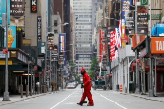 A street cleaner walks through the closed Broadway theatre district near Times Square following the outbreak of the coronavirus disease (COVID-19) in Manhattan, New York City, U.S., May 24, 2020. REUTERS/Andrew Kelly