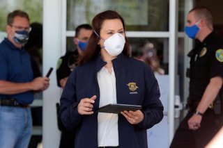 Michigan Governor Gretchen Whitmer wears a face mask as she arrives to address the media about the flooding along the Tittabawassee River, after several dams breached, in downtown Midland, Michigan U.S., May 20, 2020. REUTERS/Rebecca Cook