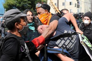 Protesters remove a man from the protest because he was bothering other protesters at the self-proclaimed Capitol Hill Autonomous Zone (CHAZ) during a protest against racial inequality and call for defunding of Seattle police, in Seattle, Washington, U.S.