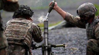 U.S. Military Academy (USMA) cadets wear protective face masks as they fire live mortar shells from an artillery weapon during tactical and physical training activities as part of Cadet Summer Training at West Point, New York, U.S., August 7, 2020. REUTER