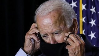 Democratic U.S.presidential candidate Joe Biden adjusts his protective face mask as he calls for the mandatory wearing of masks while speaking to reporters following a briefing on the coronavirus disease (COVID-19) pandemic with public health experts duri