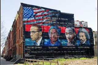 Mural on the wall of row houses in Philadelphia. The artist is Parris Stancell, sponsored by the Freedom School Mural Arts Program. 17 April 2009. Flickr/Tony Fischer. Creative Commons Attribution 2.0 Generic (CC BY 2.0)