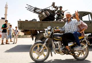 A man gestures as he rides a motorbike in Deraa, Syria, July 4, 2018. REUTERS/Omar Sanadiki