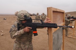 Pfc. Simeon Taylor, with Bravo Company, 427th Brigade Support Battalion, fires the German made Heckler & Koch G36 assault rifle during the qualification for the schützenschnur badge, at the German marksmanship range, on Nov. 17 in Mazare-e Sharif, Afghani