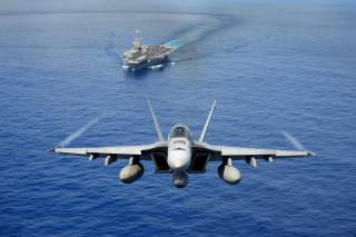 An F/A-18E Super Hornet participates in an air power demonstration near the aircraft carrier USS John C. Stennis (CVN 74) as the ship operates in the Pacific Ocean on April 24, 2013.