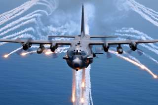 An AC-130H gunship from the 16th Special Operations Squadron, Hurlburt Field, Florida, jettisons flares as an infrared countermeasure during multi-gunship formation egress training on August 24, 2007.