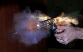 Ultra-high speed photo of bullet fired out of a S&W revolver photographed with an air-gap flash