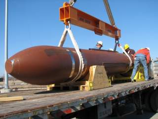 DTRA test personnel prepare to carefully off-load the 30,000 pound Massive Ordnance Penetrator (MOP) in preparation for a static test at White Sands Missile Range, N.M. (DTRA photo)