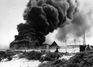 Battle of Midway, June 1942. Burning oil tanks on Sand Island, Midway, following the Japanese air attack delivered on the morning of 4 June 1942. 