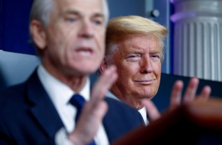 U.S. President Donald Trump listens as White House Director of Trade and Marketing Policy Peter Navarro addresses the daily coronavirus response briefing at the White House in Washington, U.S., April 2, 2020. REUTERS/Tom Brenner