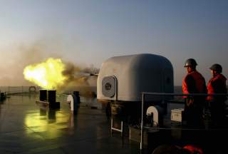 A battleship fires during an exercise on the East China Sea February 2, 2007. Picture taken February 2, 2007. CHINA OUT REUTERS/China Daily