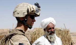 A U.S. Marine from 2nd platoon, F company, 5th batalion, 10th Marines, meets an Afghan villager during a patrol in southern Afghanistan June 28, 2009. After five years coping with the most dangerous province in Iraq, the U.S. Marines have been given their