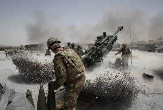 U.S. Army soldiers from the 2nd Platoon, B battery 2-8 field artillery, fire a howitzer artillery piece at Seprwan Ghar forward fire base in Panjwai district, Kandahar province southern Afghanistan, June 12, 2011. REUTERS/Baz Ratner 