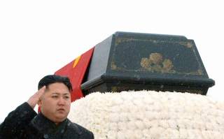 North Korea's new leader Kim Jong-un salutes as he accompanies the hearse carrying the coffin of late North Korean leader Kim Jong-il during his funeral procession in Pyongyang in this photo taken by Kyodo December 28, 2011. North Korea's military staged 