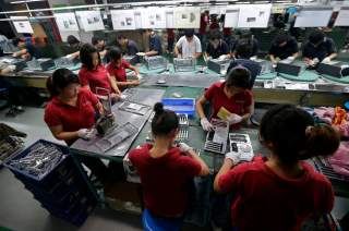 Employees work at a Foxconn factory in Wuhan, Hubei province, in this August 31, 2012 picture. REUTERS/Stringer (CHINA)