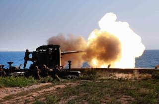 Soldiers fire an artillery piece during a visit by North Korean leader Kim Jong Un to inspect the defence detachment on Ung Islet, which is defending an outpost in the East Sea of Korea, in this undated photo released by North Korea's Korean Central News 