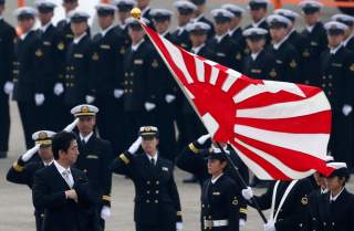 Japan's Prime Minister Shinzo Abe (L) reviews members of Japan Self-Defense Force (JSDF) during the JSDF Air Review, to celebrate 60 years since the service's founding at Hyakuri air base in Omitama, northeast of Tokyo October 26, 2014. About 740 personne