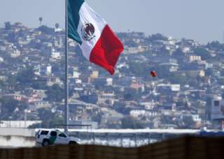 A U.S. border patrol officer sits in his vehicle looking out over Tijuana, Mexico from San Ysidro, California February 25, 2015. U.S. Senate leaders took a tentative step on Tuesday that could avert a partial shutdown of the Department of Homeland Securit