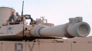 U.S. troops sit on an Abrams M1 tank as they prepare to join a military offensive in the northern Iraq city of Tal Afar September 10, 2005.