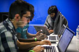 Mehmet Efe Akengin, Hassan Kane and Surya Bhupatiraju (L-R) work late into the night on computers during a weekend Hackathon event, in San Francisco, California, U.S. July 17, 2016. REUTERS/Gabrielle Lurie SEARCH 