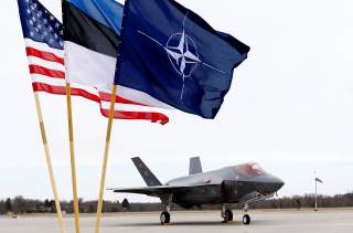 U.S., Estonia's and NATO flags flutter next to the U.S. Air Force F-35A Lightning II fighter in Amari air base, Estonia, April 25, 2017. REUTERS/Ints Kalnins