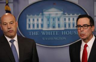 U.S. National Economic Director Gary Cohn (L) and Treasury Secretary Steven Mnuchin react to questions while unveiling the Trump administration's tax reform proposal in the White House briefing room in Washington, U.S, April 26, 2017. REUTERS/Carlos Barri