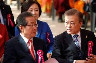 Moon Jae-in (R), presidential candidate of the Democratic Party of Korea, talks with Hong Joon-pyo, presidential candidate of the Liberty Korea Party, during a ceremony celebrating the birthday of Buddha at Jogye temple in Seoul, South Korea, May 3, 2017.