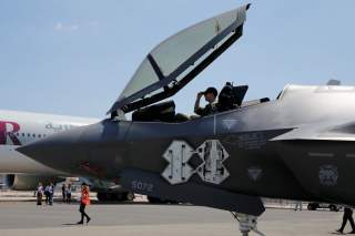 A U.S. airman adjusts his cap in the cockpit as a Lockheed Martin F-35 Lightning II aircraft is moved on the eve of the 52nd Paris Air Show at Le Bourget Airport near Paris, France June 18, 2017. REUTERS/Pascal Rossignol