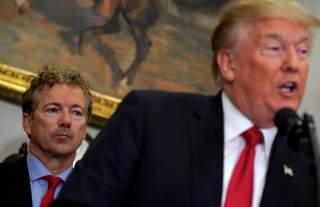 U.S. Senator Rand Paul (R-KY) listens as U.S. President Donald Trump speaks before signing an executive order making it easier for Americans to buy bare-bones health insurance plans and circumvent Obamacare rules at the White House