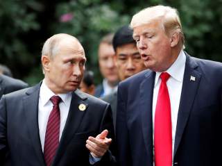 U.S. President Donald Trump and Russia's President Vladimir Putin talk during the family photo session at the APEC Summit in Danang, Vietnam November 11, 2017. REUTERS/Jorge Silva TPX IMAGES OF THE DAY