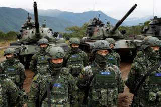 Taiwanese soldiers stand in front of M60A3 tanks during a military drill in Hualien, eastern Taiwan, January 30, 2018. REUTERS/Tyrone Siu