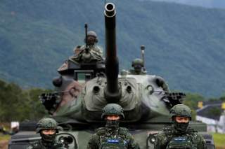 Taiwanese soldiers stand in front of a M60A3 tank during a military drill in Hualien, eastern Taiwan, January 30, 2018. REUTERS/Tyrone Siu