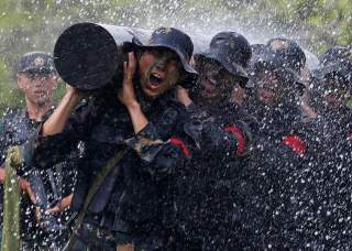 People's Liberation Army soldiers perform at an airbase in Hong Kong, China June 30, 2018, a day before the 21st anniversary of the city's return to Chinese sovereignty from British rule. REUTERS/Bobby Yip