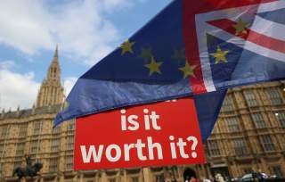 Pro-EU supporters wave flags outside the Houses of Parliament in Westminster, London, Britain, July 4, 2018.REUTERS/Simon Dawson