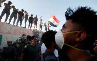 Iraqi protesters stand on concrete blast walls during a protest near the building of the government office in Basra, Iraq September 6, 2018. REUTERS/Essam al-Sudani