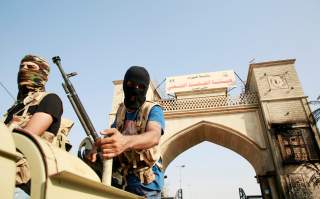 Iraqi Popular Mobilization Forces members guard near the building belonging to a Popular Mobilization Forces in Basra, Iraq September 8, 2018. REUTERS/Alaa al-Marjani