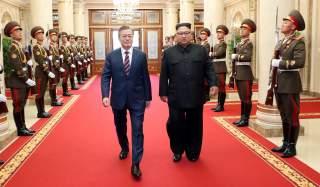 South Korean President Moon Jae-in is greeted by North Korean leader Kim Jong Un as he arrives at the headquarters of the Central Committee of the Workers' Party of Korea for their meeting in Pyongyang, North Korea, September 18, 2018. Pyeongyang Press Co