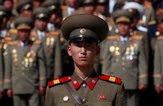 A soldier wears a badge with portraits of late North Korean leaders Kim Il Sung and Kim Jong Il as he attends a military parade marking the 70th anniversary of North Korea's foundation in Pyongyang, North Korea, September 9, 2018. REUTERS/Danish Siddiqui 