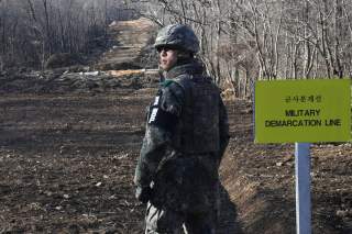 A South Korean soldier stands at the Arrowhead ridge, a site of fierce battles in the 1950-53 Korean War, to build a tactical road across the Military Demarcation Line inside the Demilitarized Zone (DMZ), in the central section of the inter-Korean border 