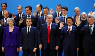 Britain's Prime Minister Theresa May, French President Emmanuel Macron, U.S. President Donald Trump, Japanese Prime Minister Shinzo Abe, Argentina's President Mauricio Macri and G20 leaders pose for a family photo during the G20 summit in Buenos Aires, Ar