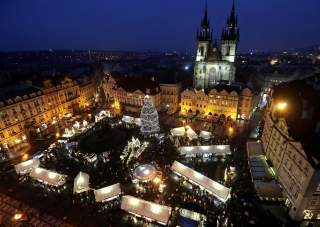 A Christmas tree is illuminated as people visit the traditional Christmas market at the Old Town Square in Prague, Czech Republic, December 2, 2018. REUTERS/David W Cerny
