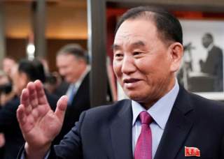 Vice Chairman of the North Korean Workers' Party Committee Kim Yong Chol, North Korea's lead negotiator in nuclear diplomacy with the United States, waves as he meets with U.S. Secretary of State Mike Pompeo (reflected in background 2ndL) for talks aimed 