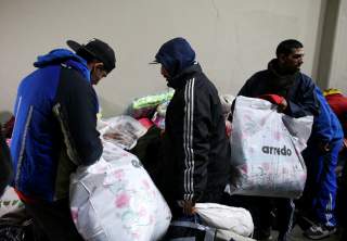 Homeless people receive donations at Argentine soccer team River Plate's stadium in Buenos Aires, Argentina, July 3, 2019. REUTERS/Agustin Marcarian